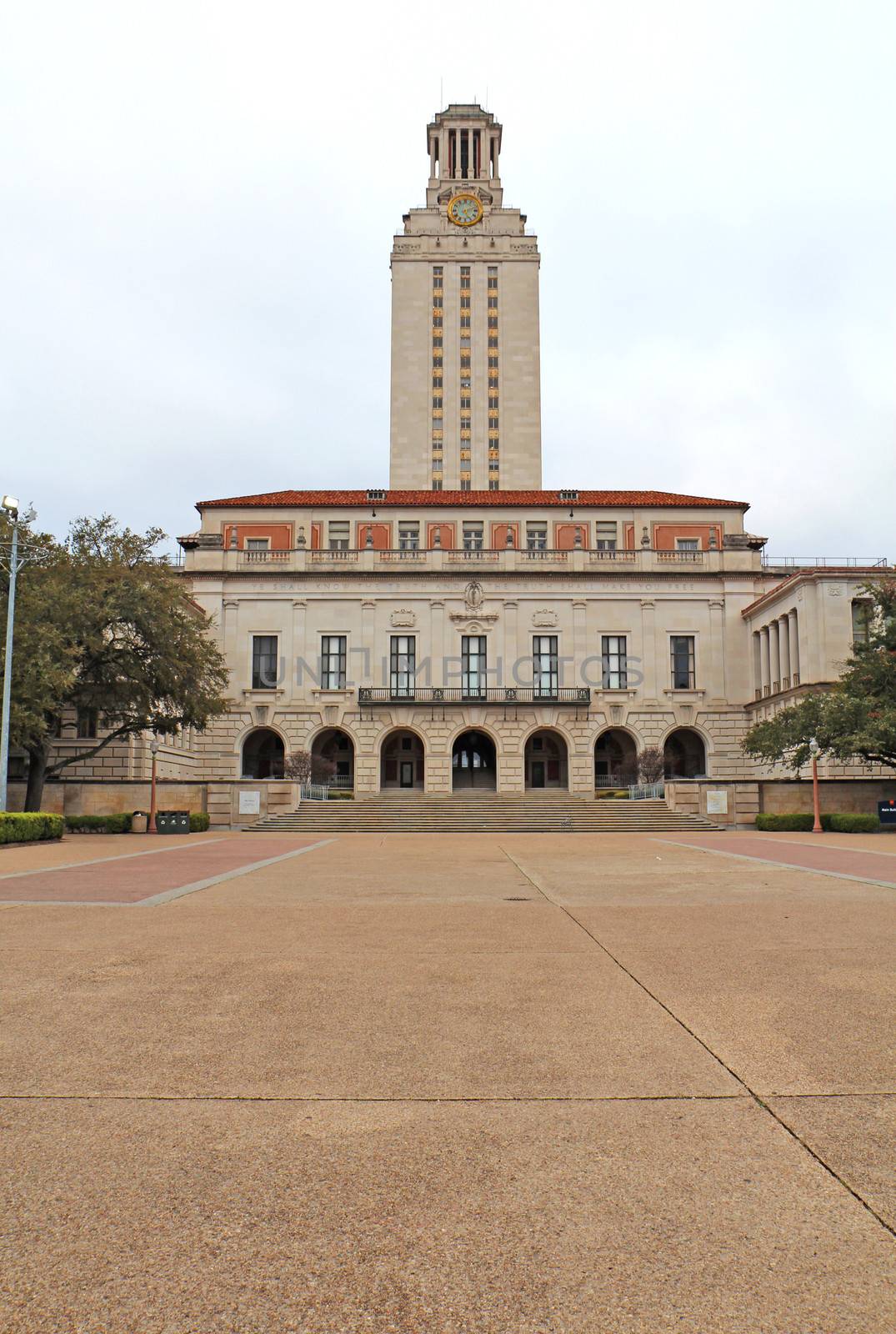 Main Building (or The Tower) on the campus of the University of Texas at Austin against a cloudy sky vertical. This clock tower was completed in 1937 and is a main focal point of the campus.