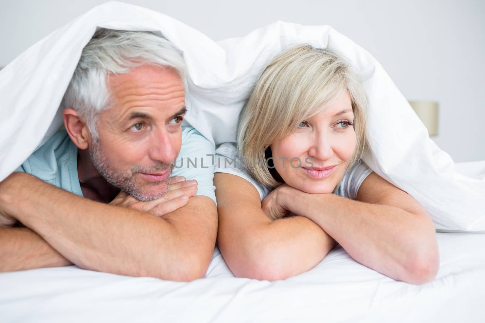 Closeup of a mature couple lying in bed by Wavebreakmedia