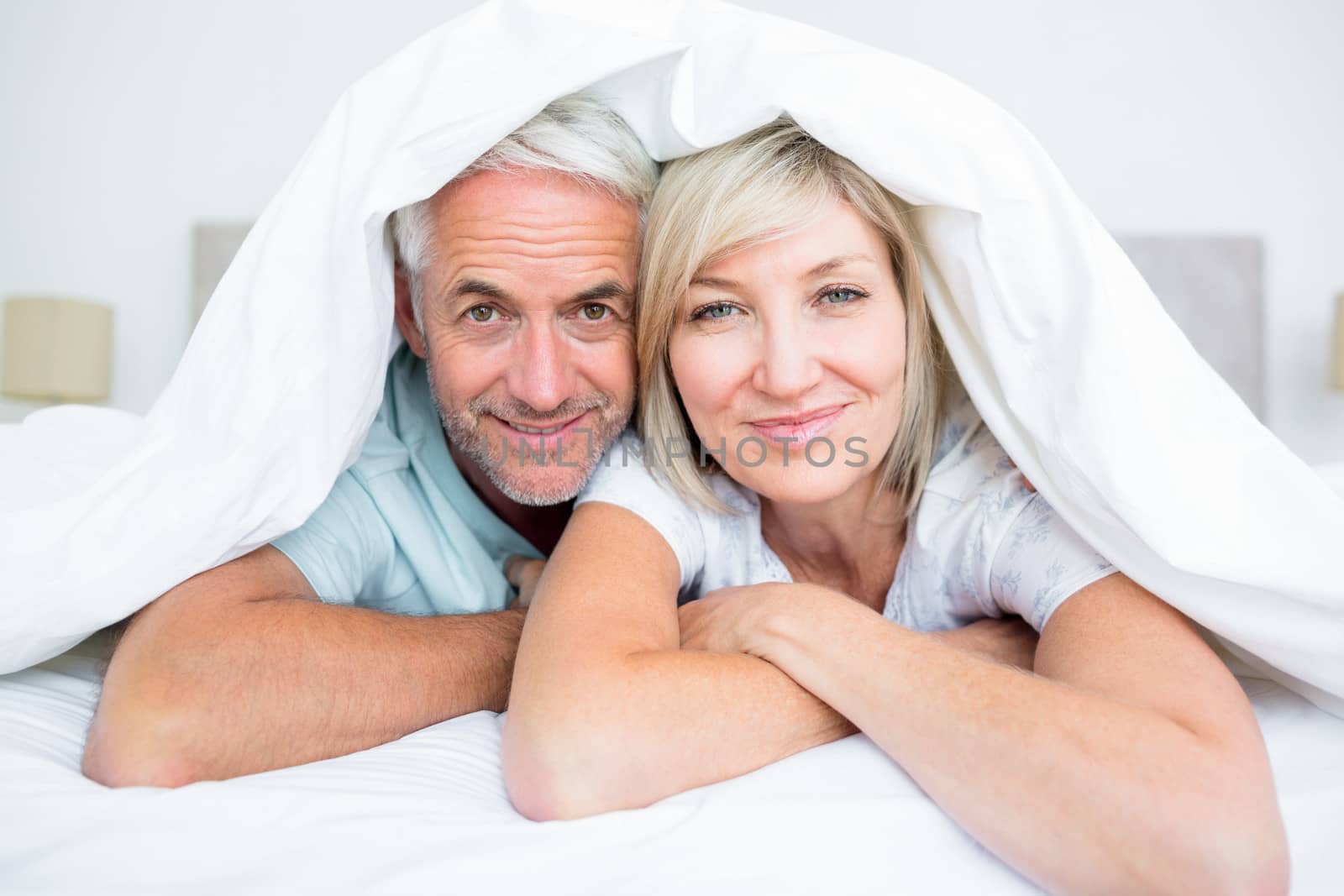 Portrait of a mature couple lying in bed by Wavebreakmedia