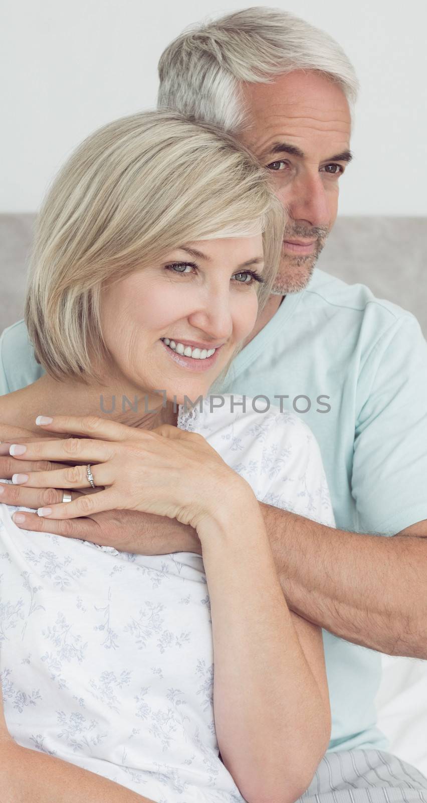 Closeup portrait of a loving mature couple in bed at home