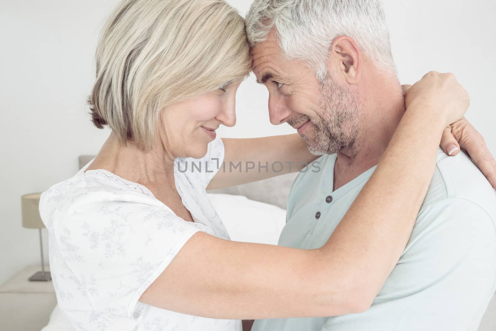Closeup side view of a loving mature couple at home