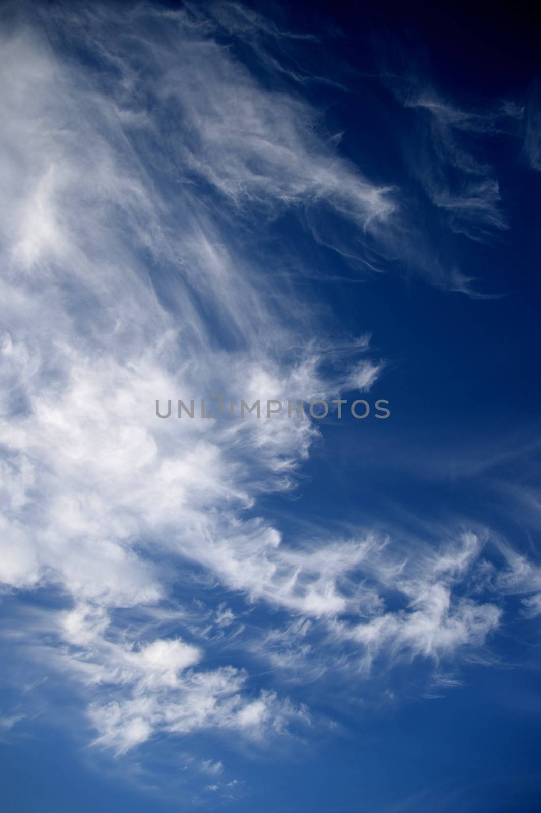 A contrasty blue cloudy sky photographed during the day