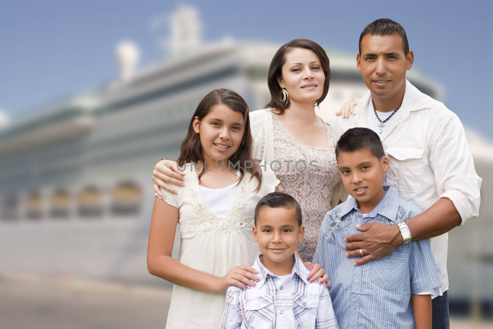 Young Happy Hispanic Family On The Dock In Front of a Cruise Ship.