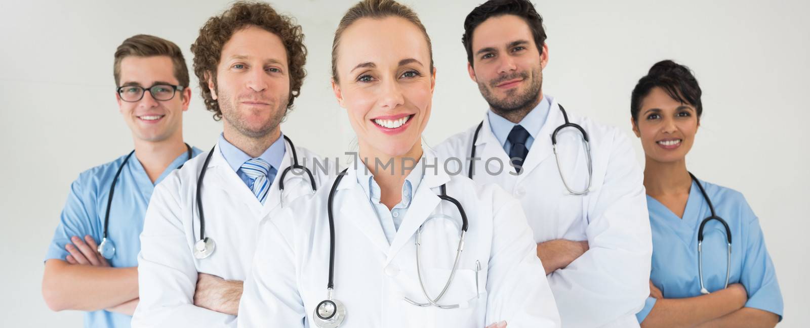 Portrait of happy medical team standing together in hospital