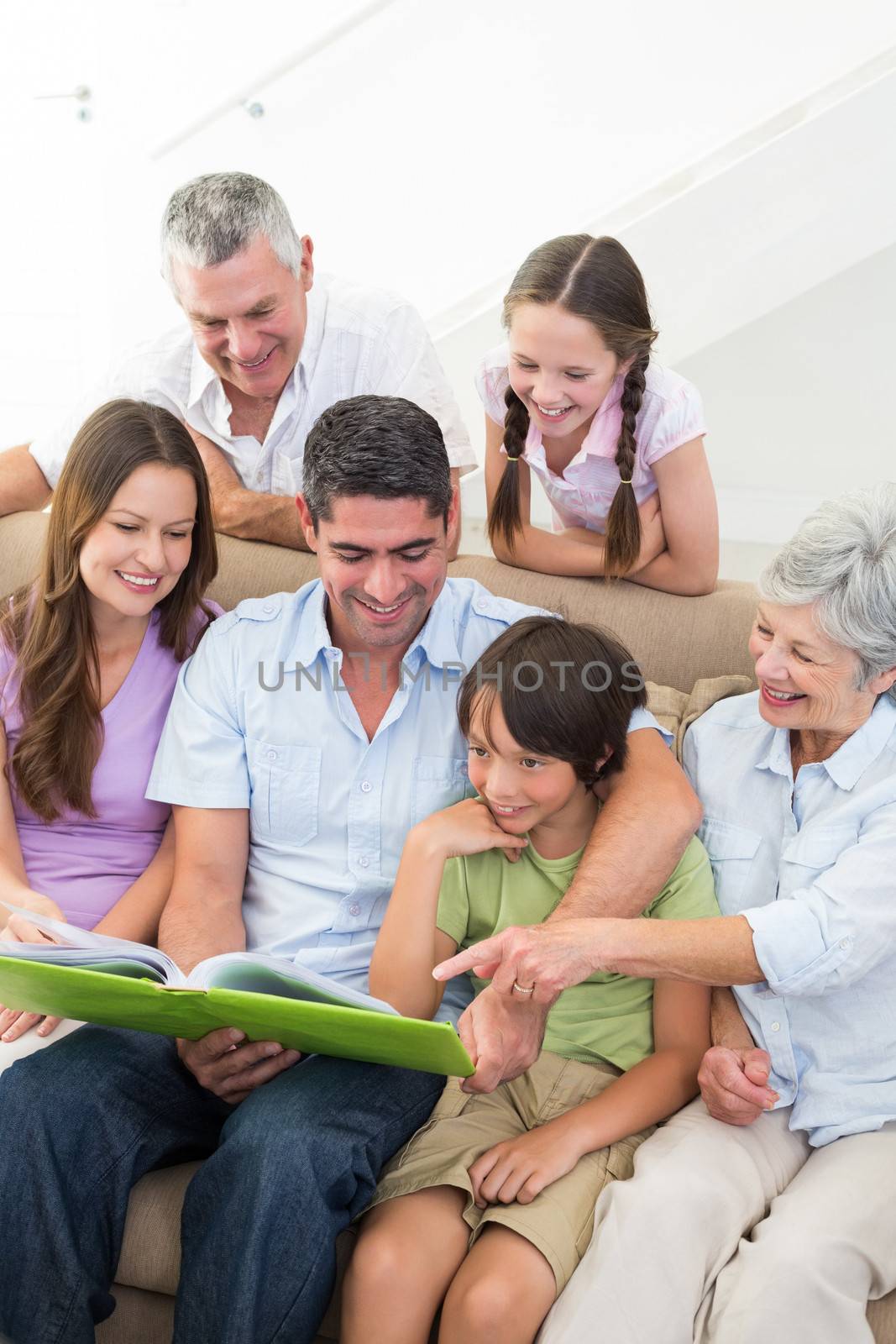 Happy family reading book  by Wavebreakmedia
