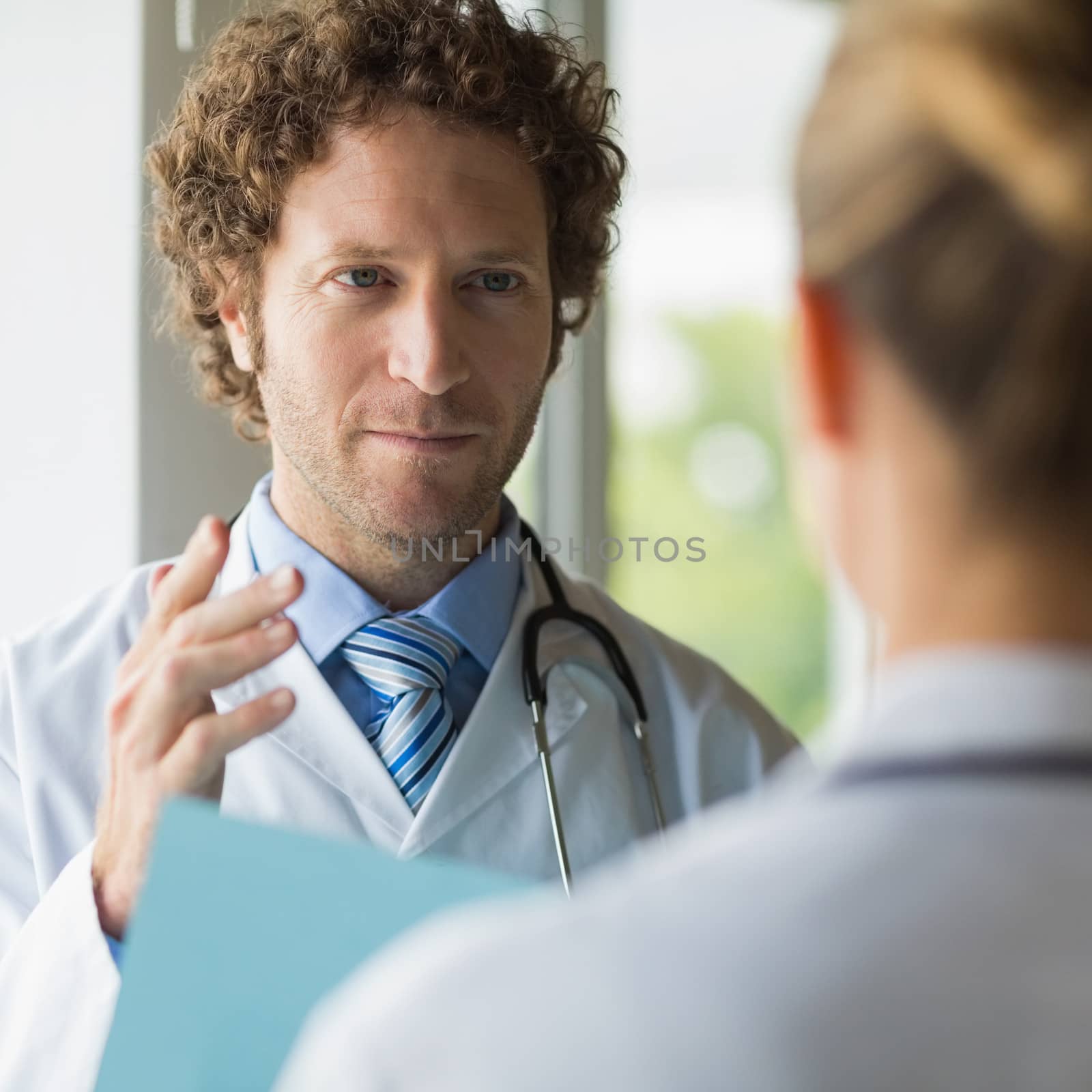 Doctor discussing with female colleague in hospital