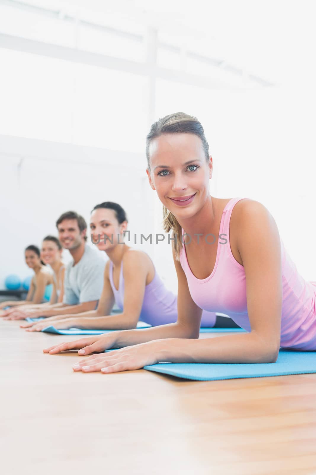 Portrait of fit class exercising at fitness studio by Wavebreakmedia