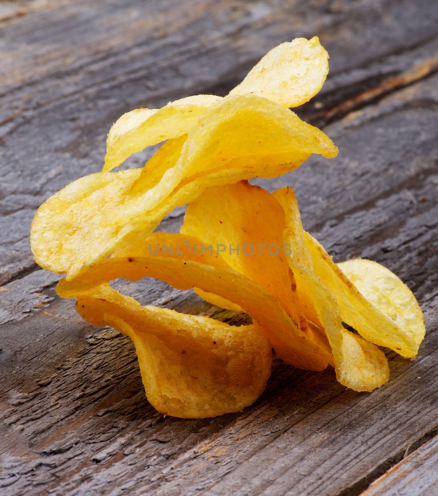 Stack of Crispy Cheese Potato Chips closeup on Rustic Wooden background