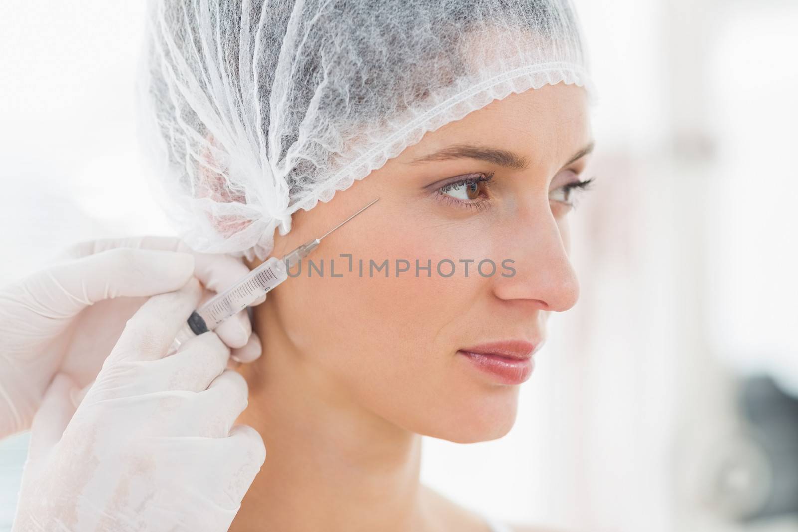 Woman receiving botox injection by Wavebreakmedia