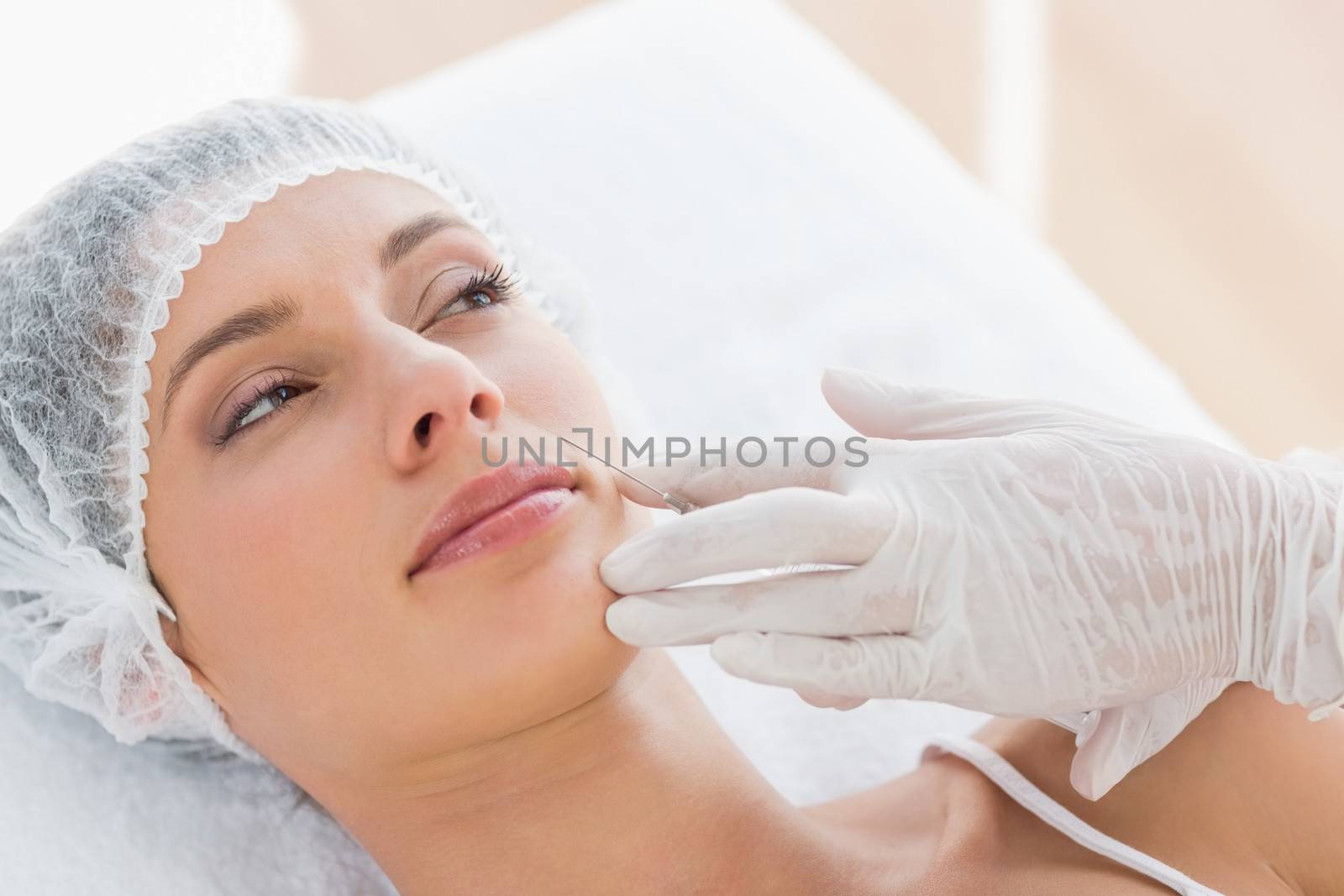 Woman recieving botox injection by Wavebreakmedia