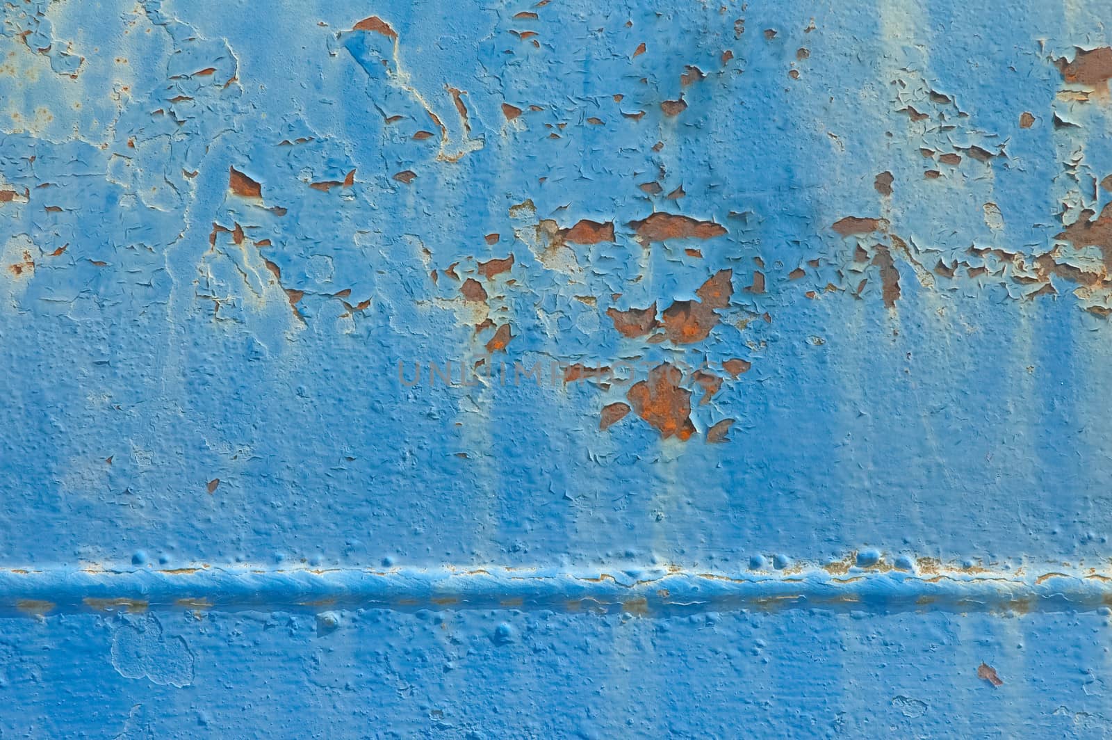 background of rusting metal with flaking blue paintwork