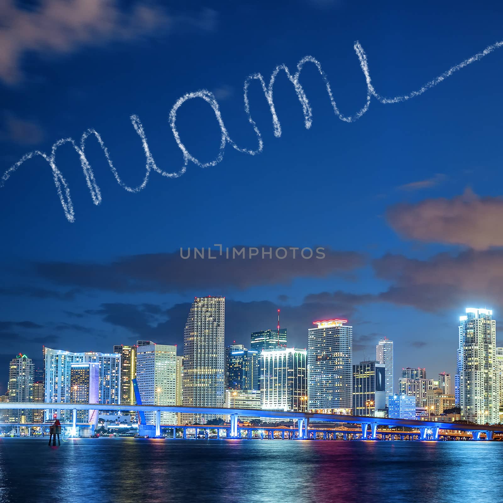 Miami Florida, summer sunset panorama with colorful illuminated business and residential buildings and bridge on Biscayne Bay 