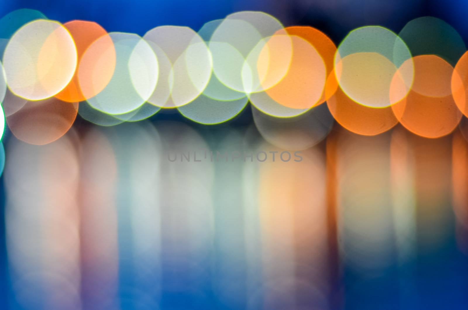 Abstract Of Defocussed Lights Over The Water At Sunset