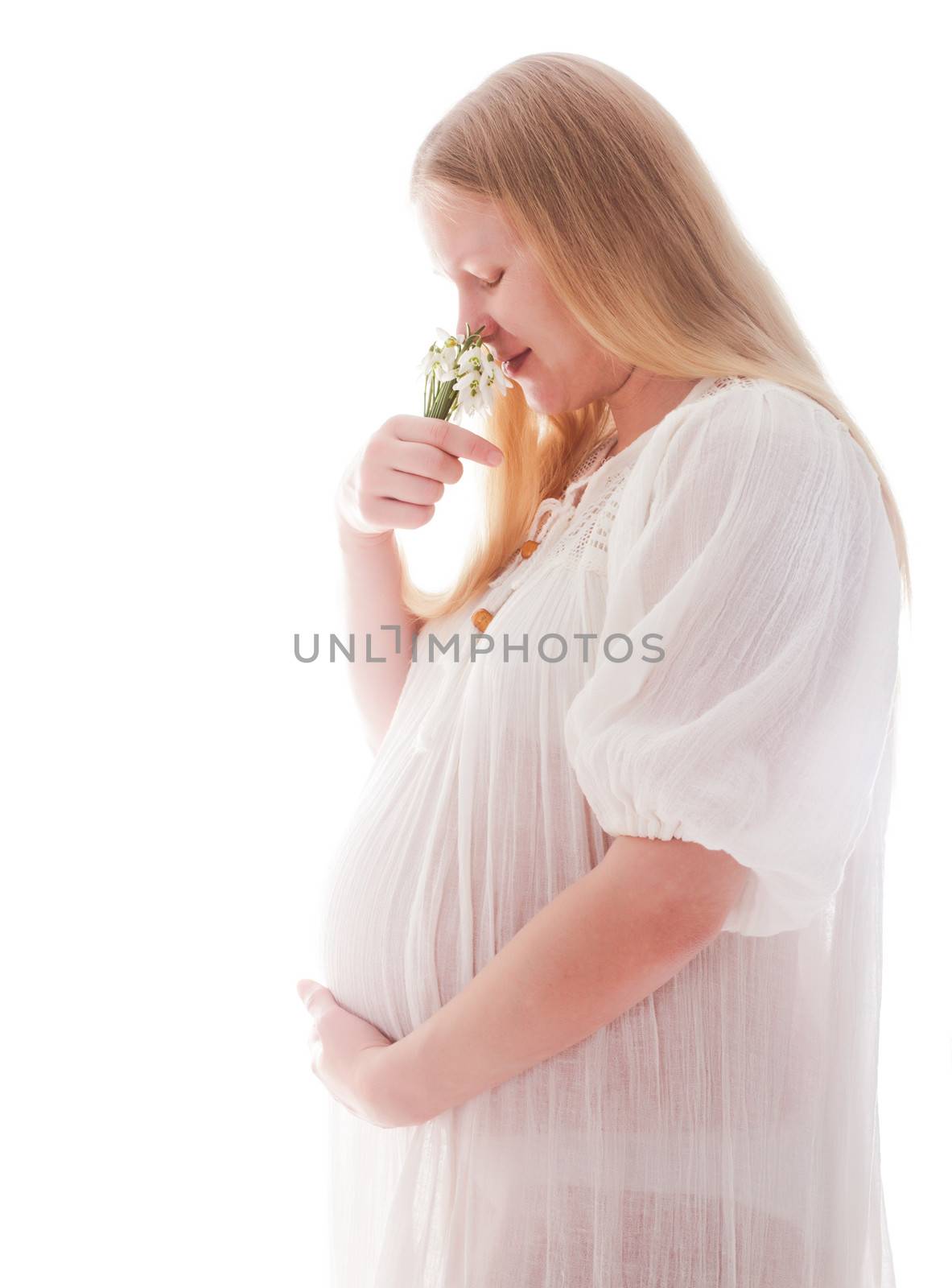 Blonde caucasian pregnant woman with snowdrops isolated on white