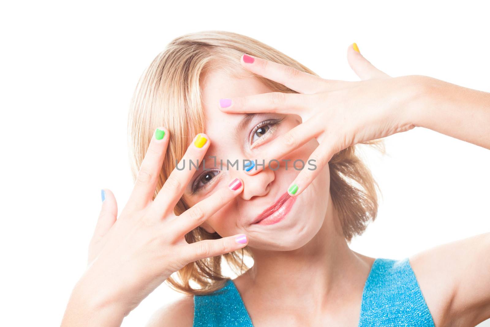 Teenager blonde girl's face with multicoloured nails close up