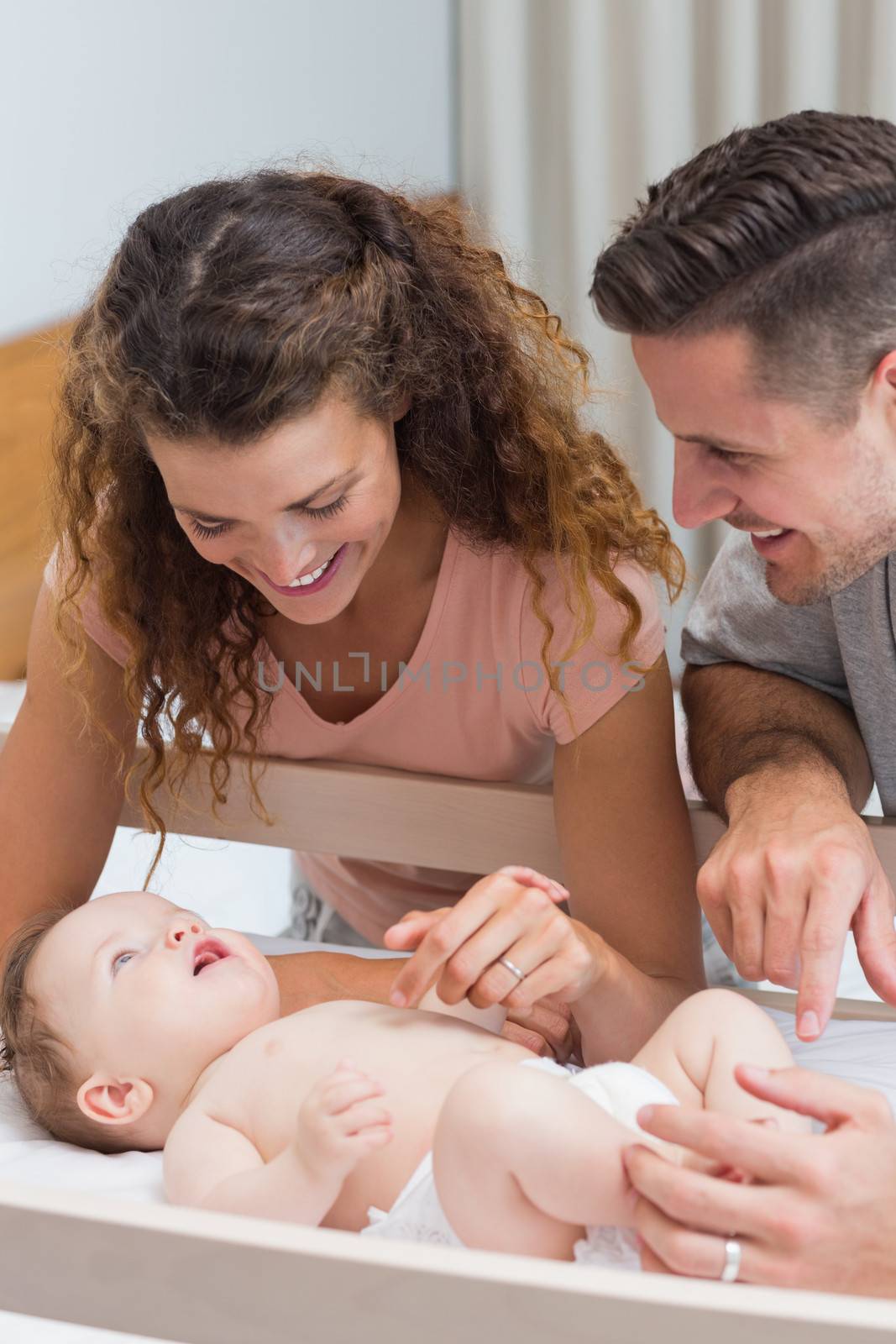 Happy parents playing with baby by Wavebreakmedia