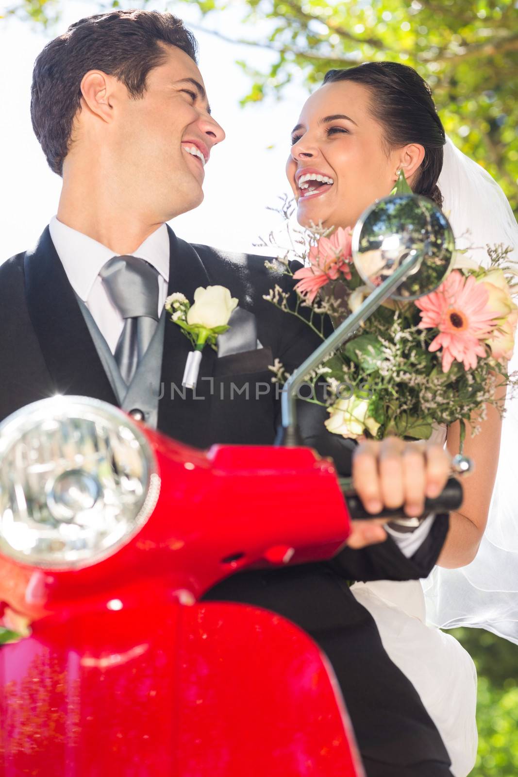 Portrait of a newlywed couple enjoying scooter ride