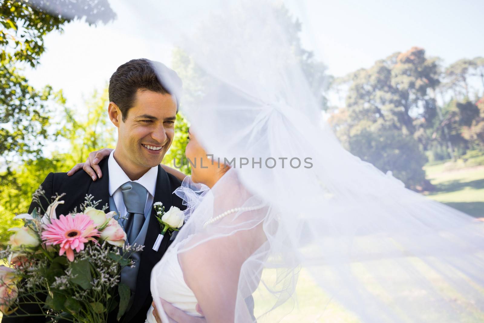 Romantic newlywed looking at each other in park by Wavebreakmedia