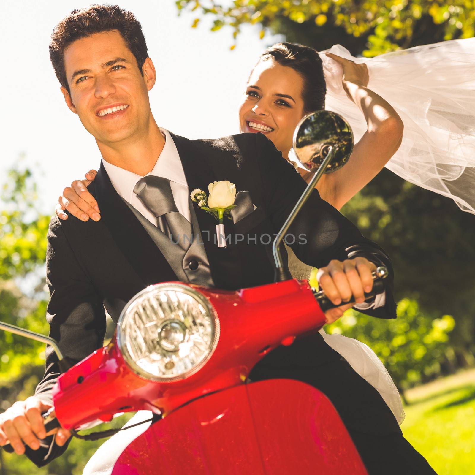 Portrait of a newlywed couple enjoying scooter ride