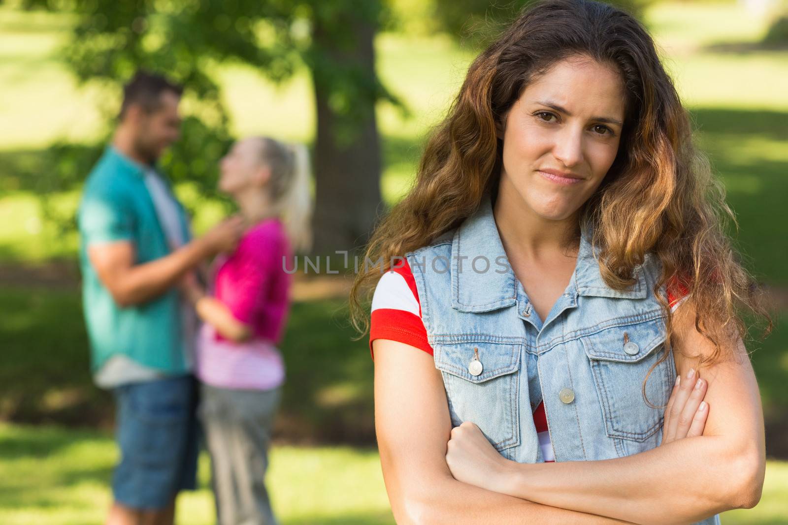 Portrait of an angry woman with man and girlfriend in background at the park