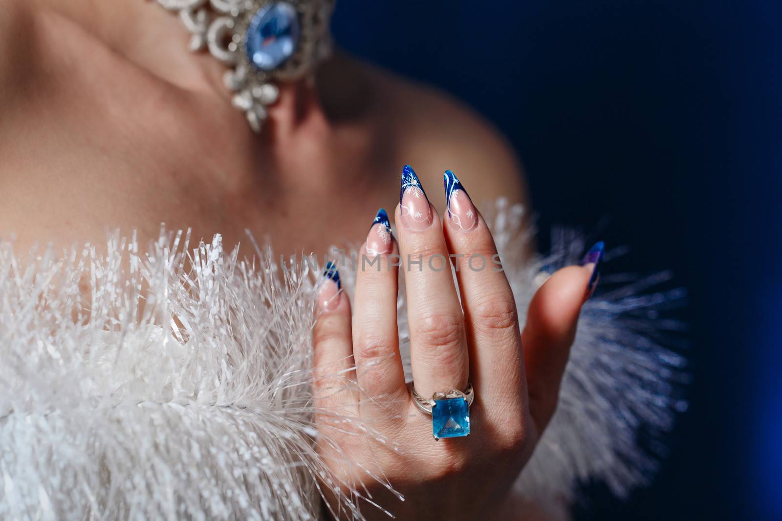 Crack nail polish on female fingers and beautiful jewels shot closeup