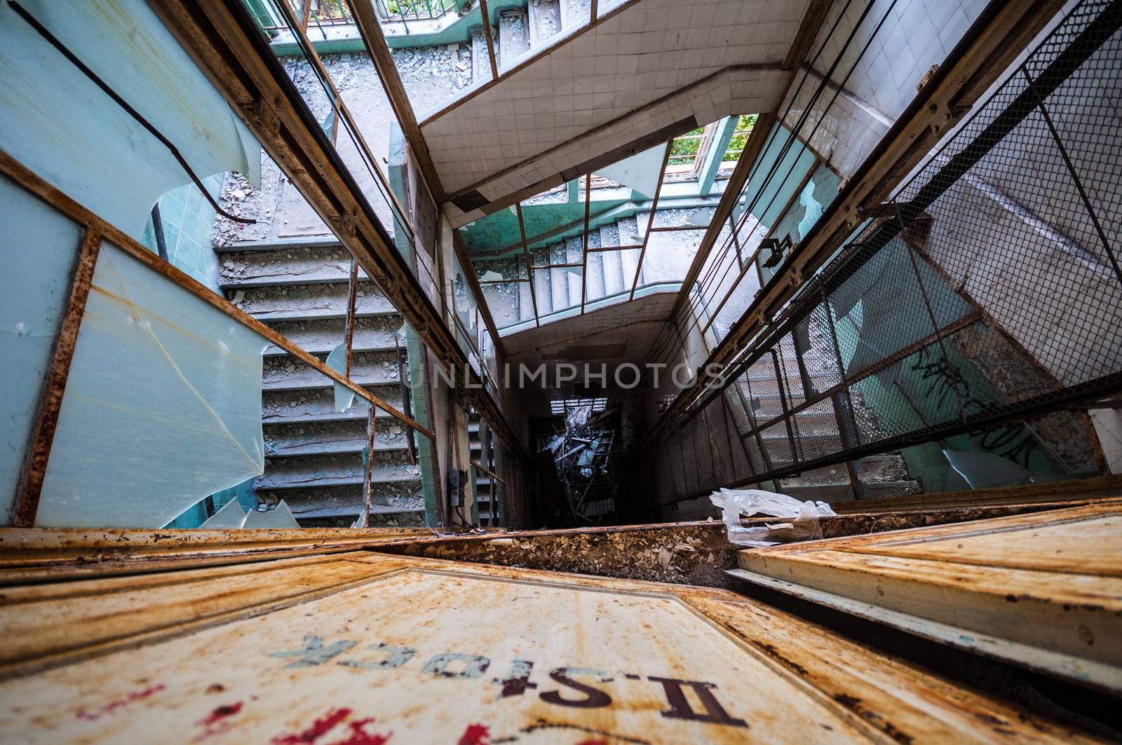 looking down an elevator shaft surrounded by stairs