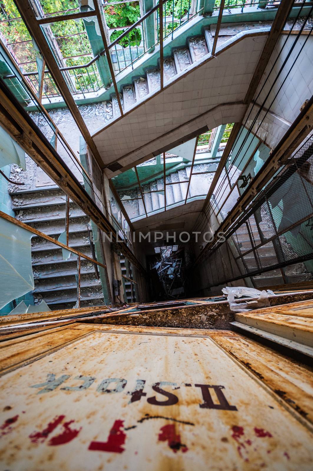 looking down an elevator shaft surrounded by stairs