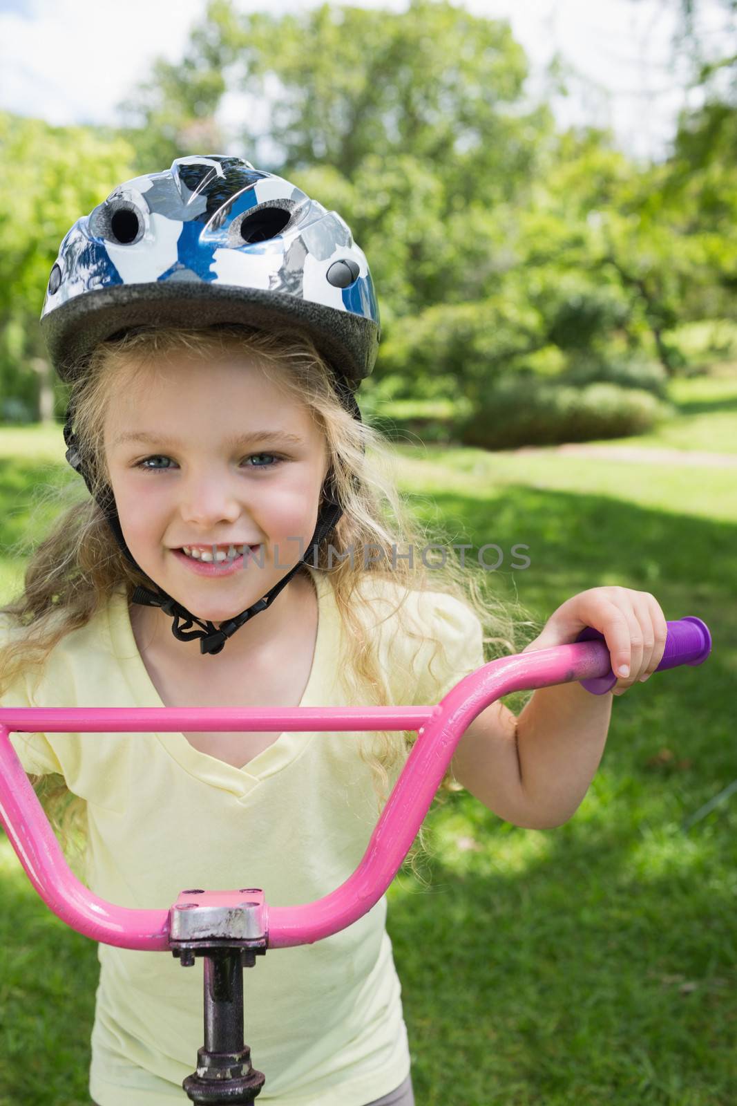 Close-up of a little girl on a bicycle at park by Wavebreakmedia