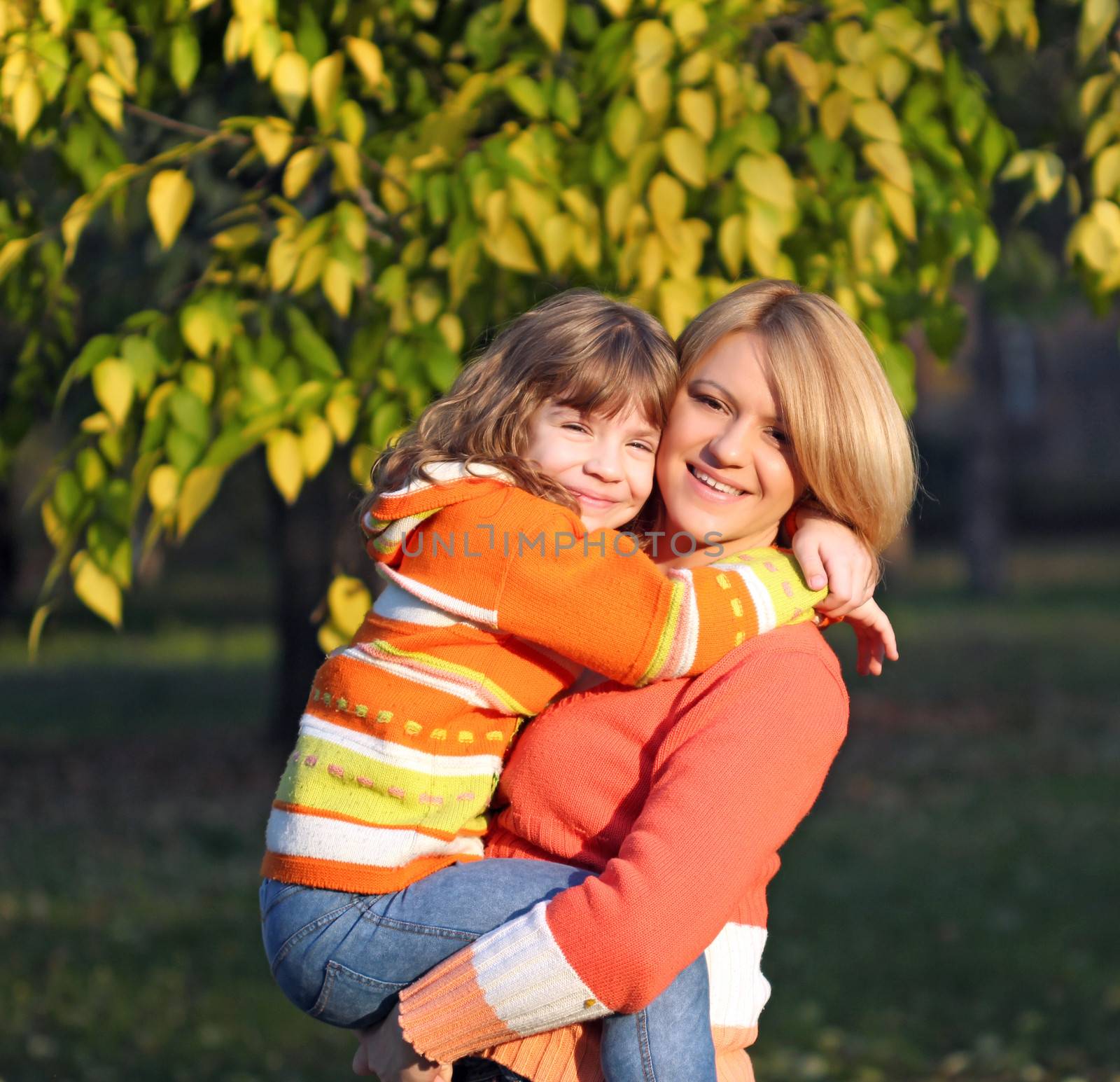 happy mother and daughter in park by goce