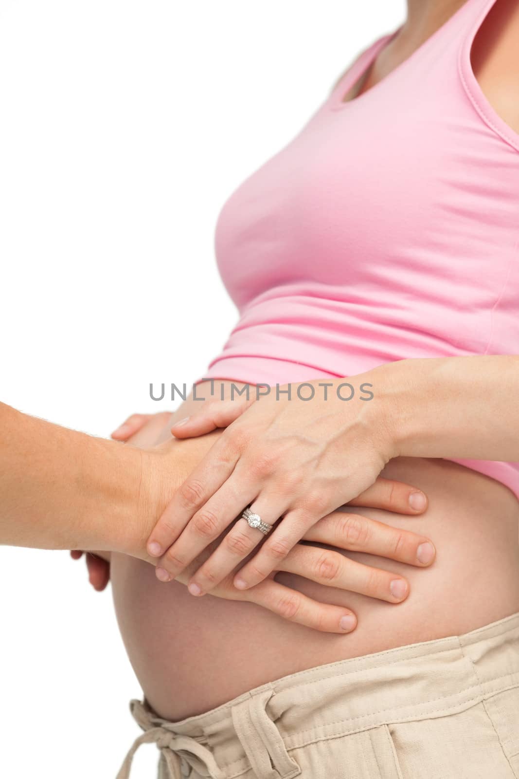 Expectant father touching mothers bump by Wavebreakmedia