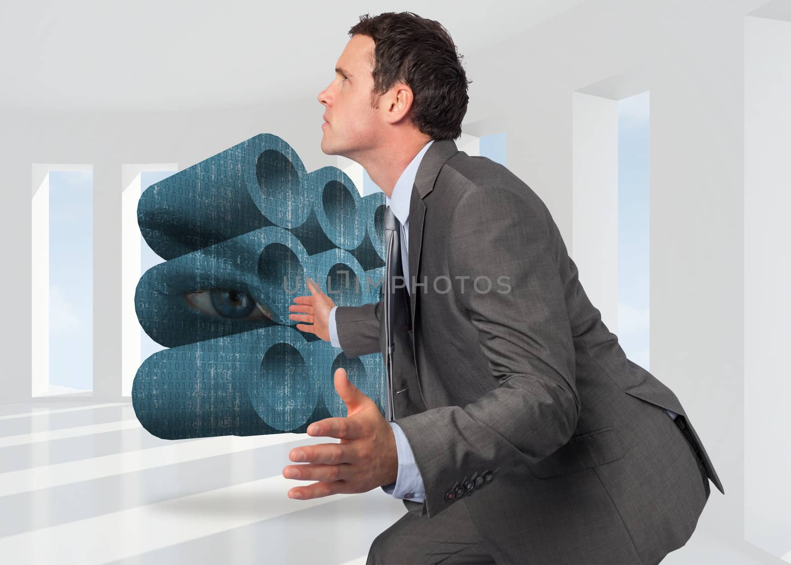 Businessman posing with hands out against bright white room with windows