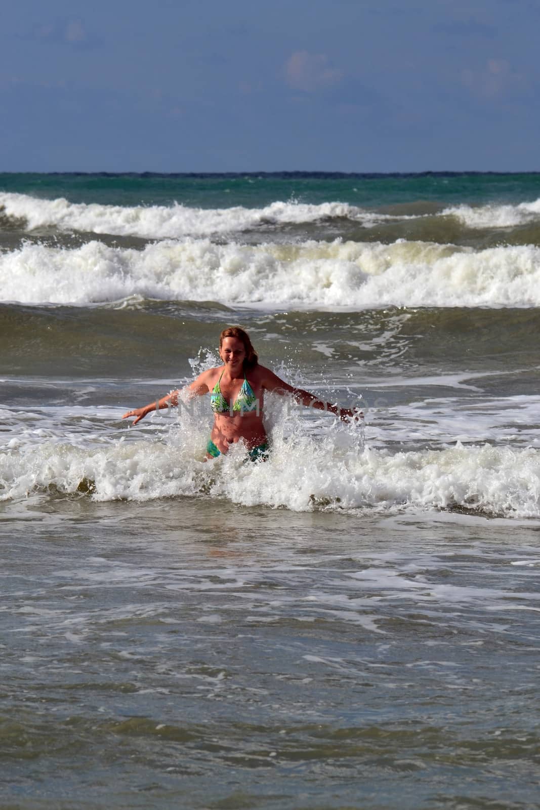 The woman in the sea against big waves. by veronka72