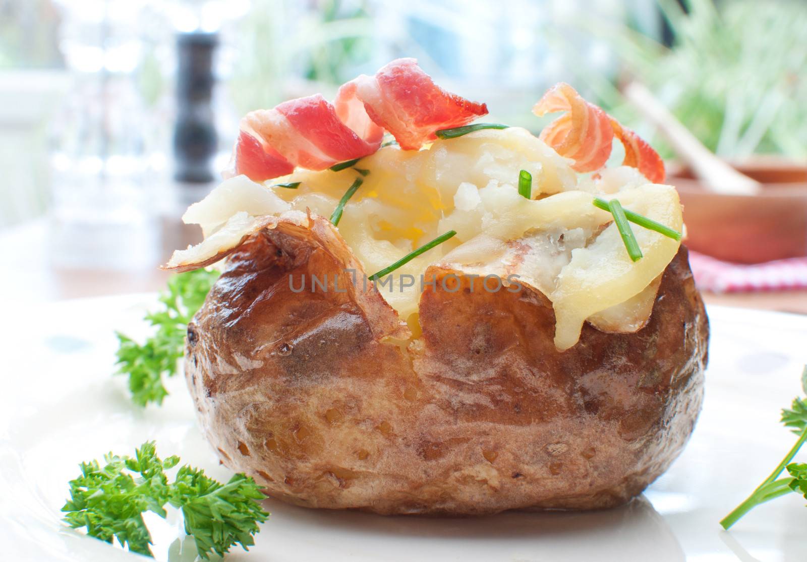 Cooked potato with curly bacon and chives