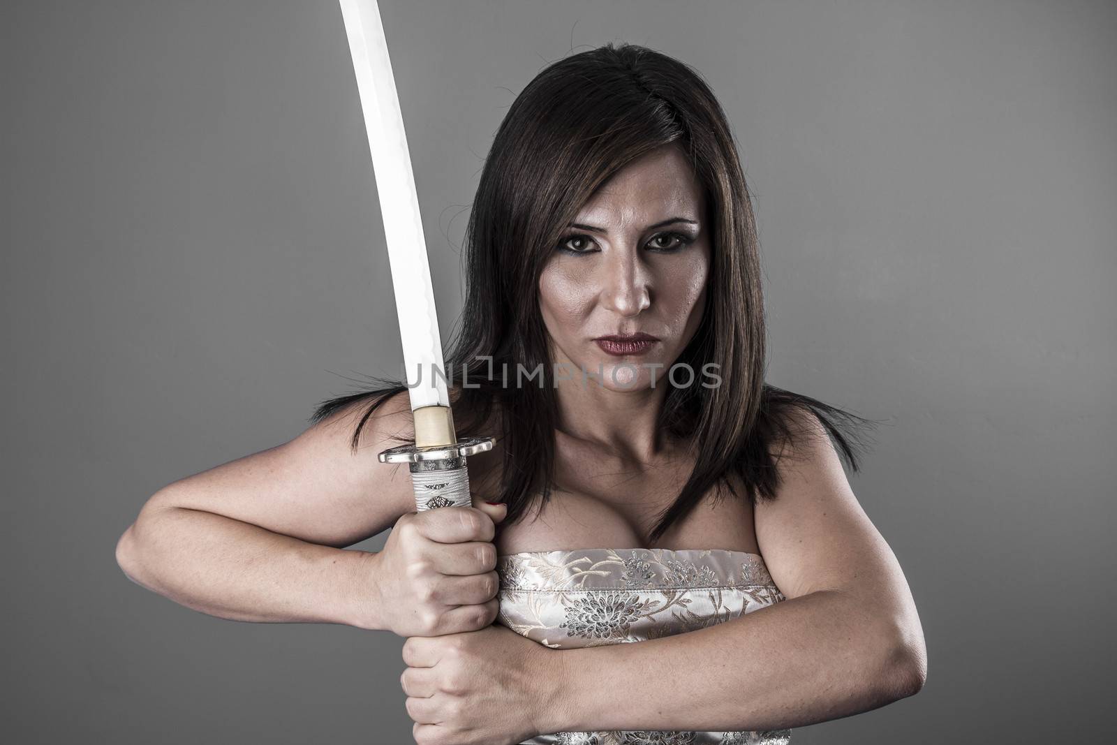 Samurai.Anime stylized brunette with short hair holding a katana sword with two hands