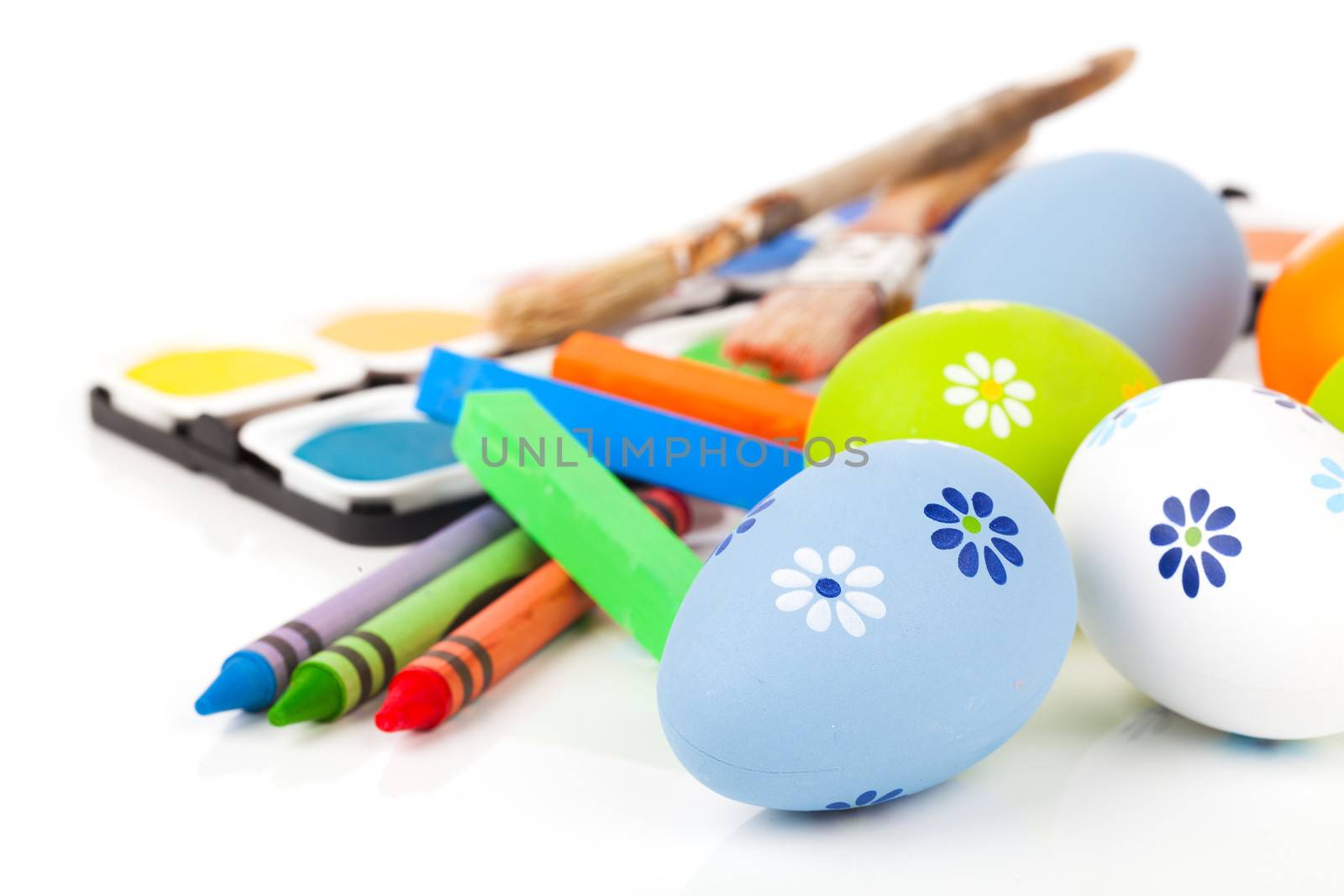 painting easter eggs on a white background.