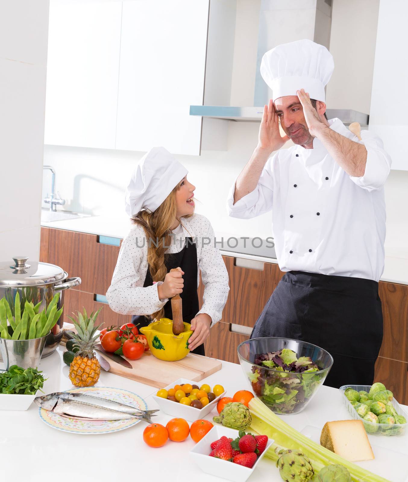 Chef master and junior kid girl at cooking school crazy man about pupil recipe