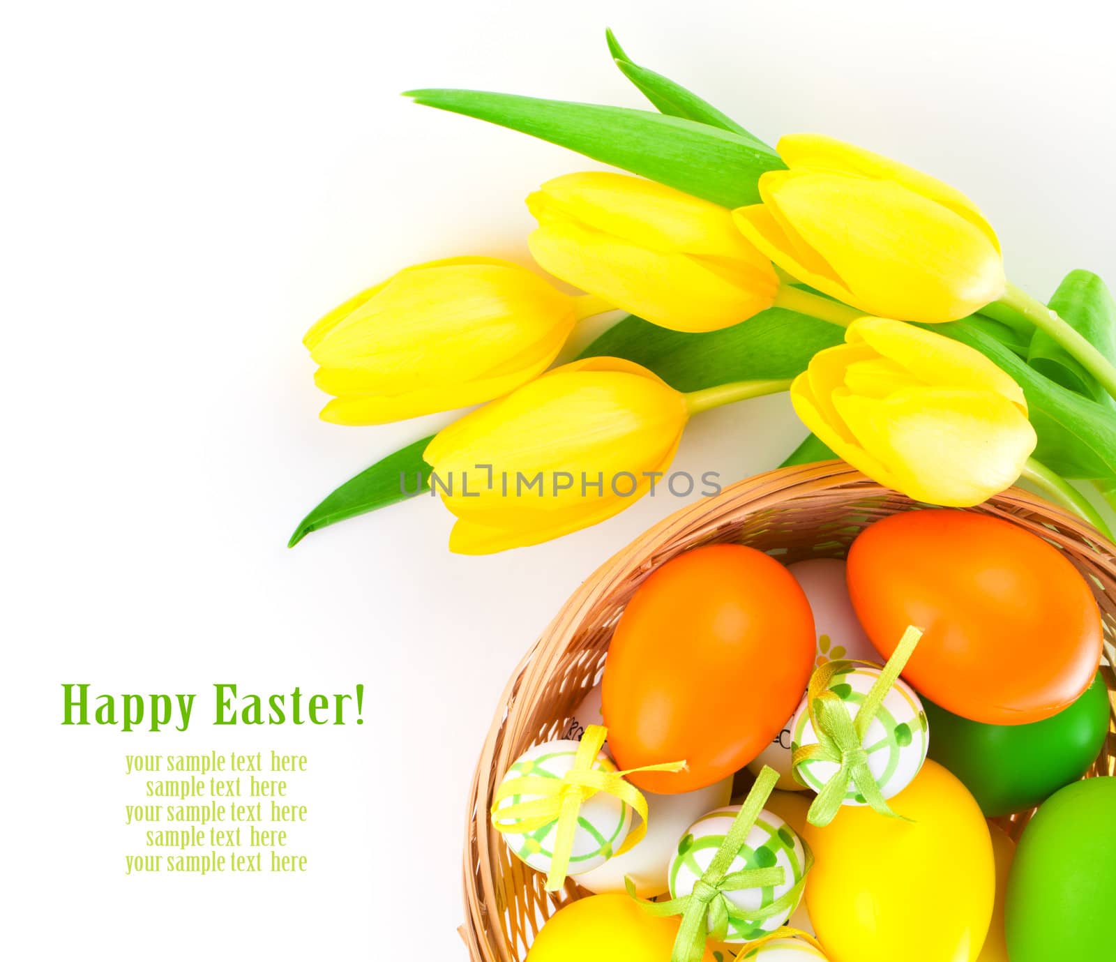 Easter eggs in a basket with yellow tulips flowers, on a white background.