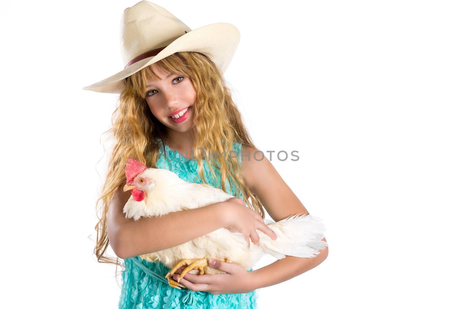 Blond kid girl farmer holding white hen on arms by lunamarina