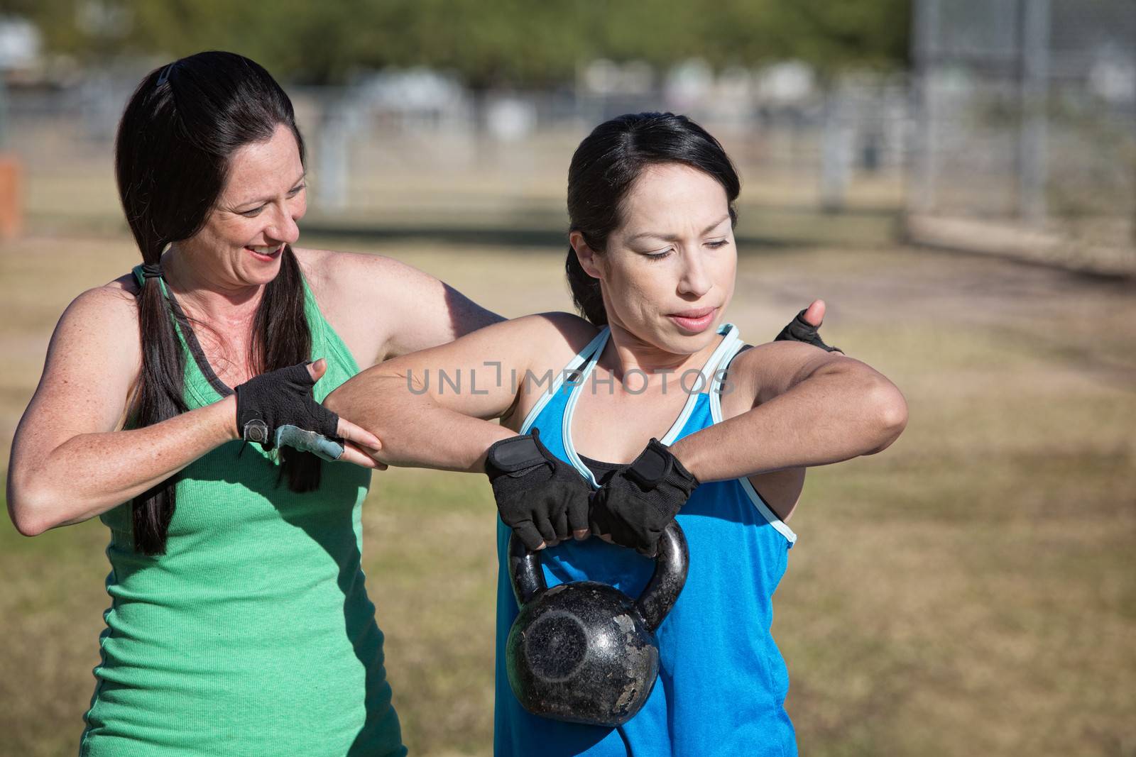 Two women working out with kettle bell weights