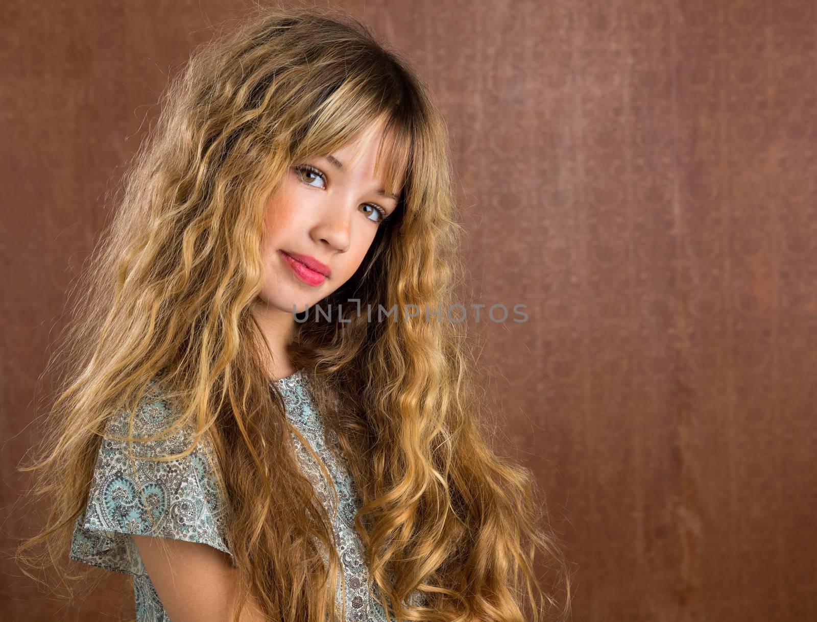 Blond kid girl curly hair portrait on retro vintage brown background