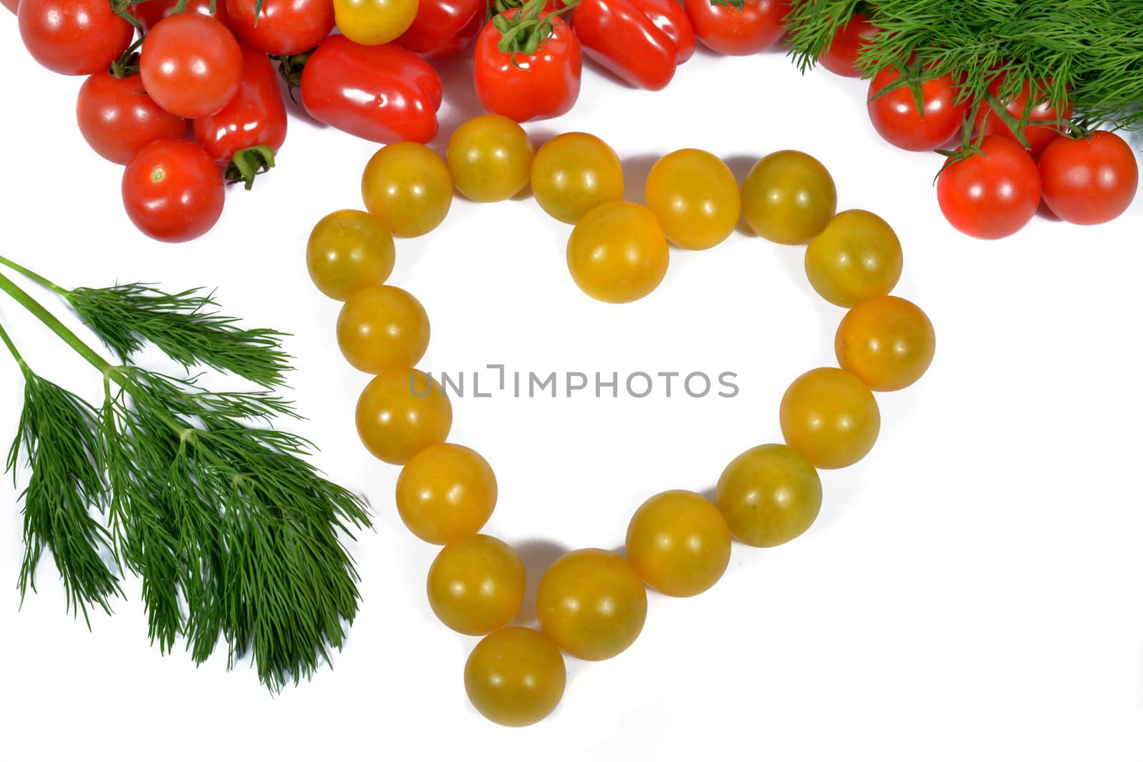 small yellow tomatoes forming a heart by philipimage