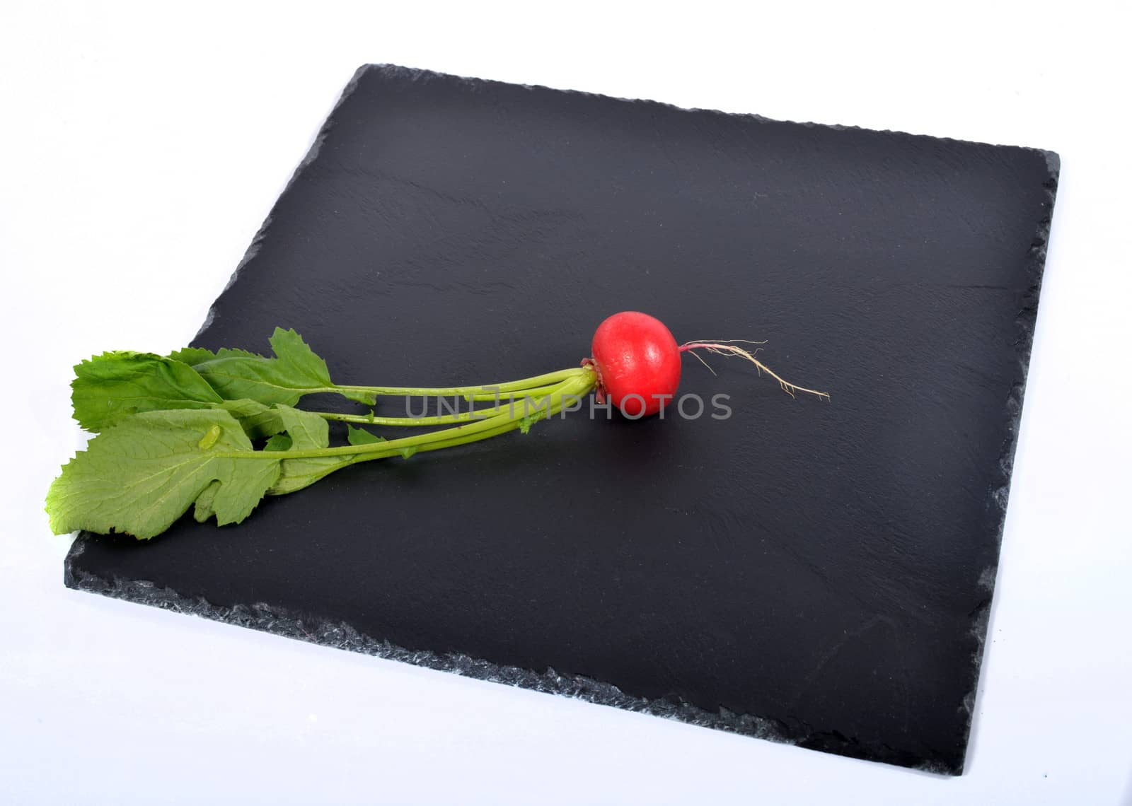 red radish on the black plate