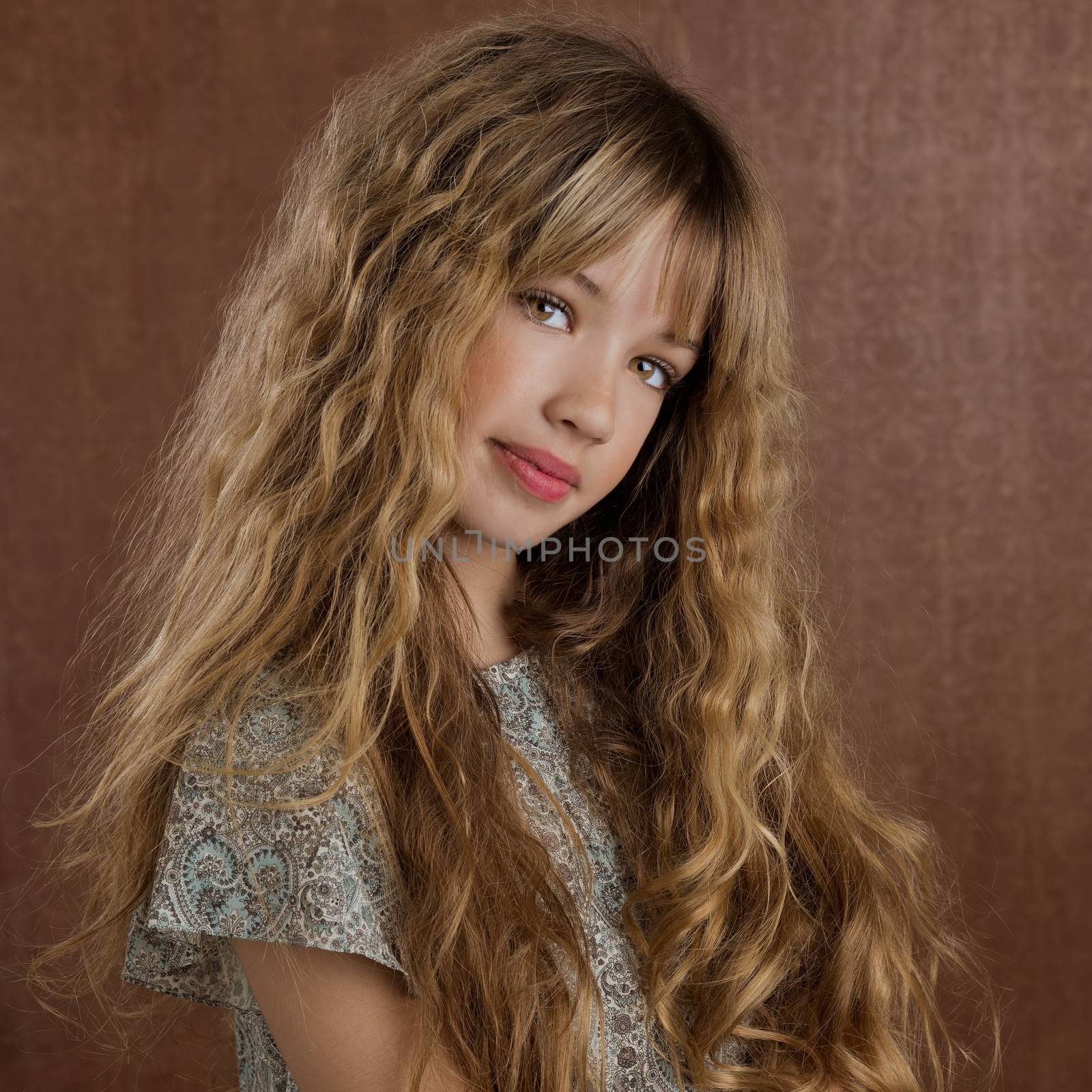 Blond kid girl curly hair portrait on retro vintage brown background