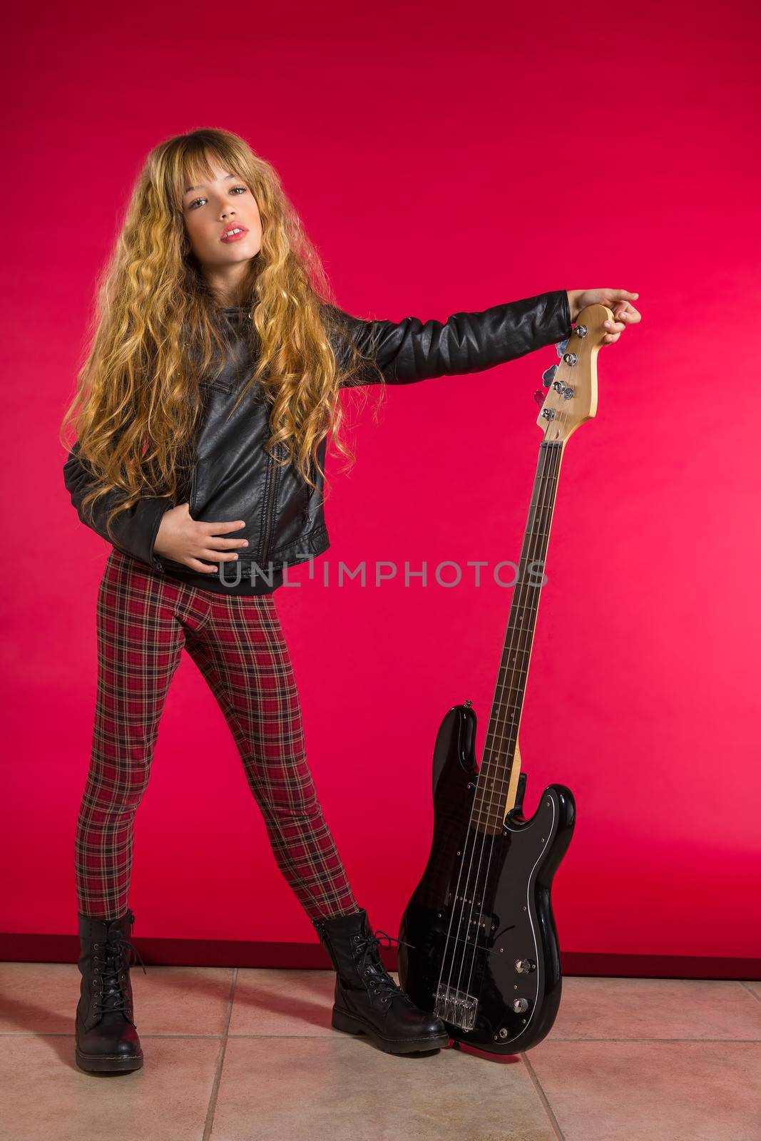 Blond Rock and roll girl bass guitar player on red background