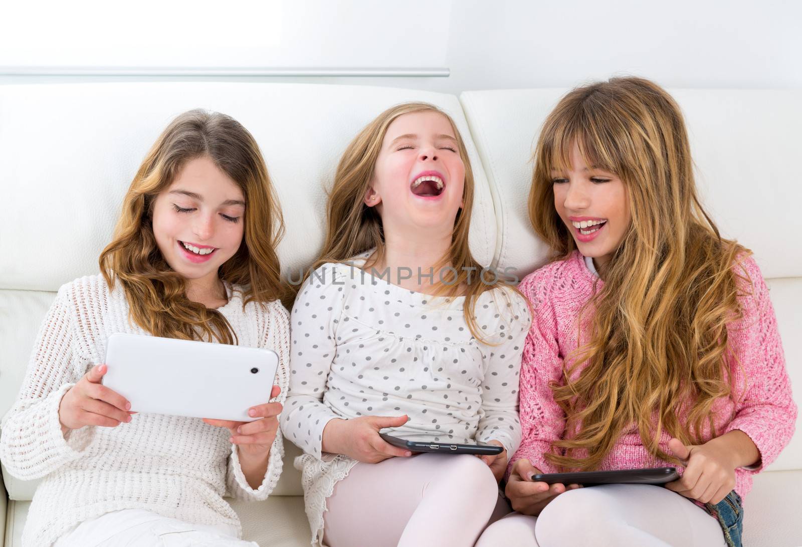 three kid sister friends girls group playing together with table by lunamarina