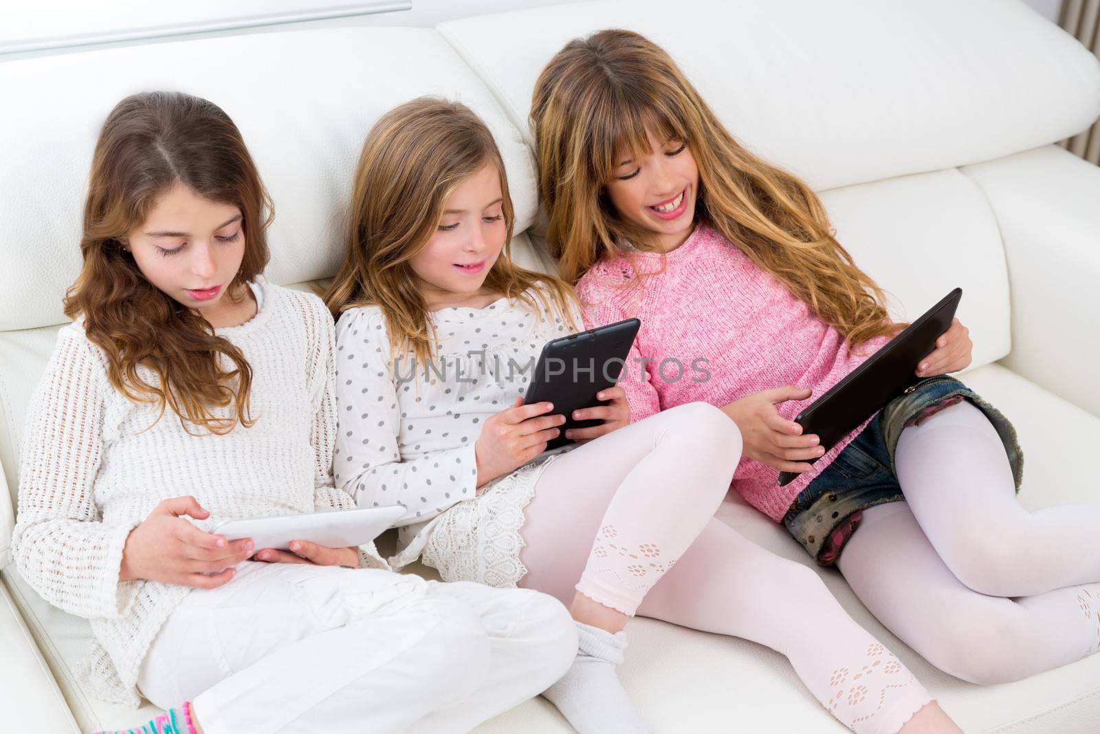 three kid sister friends girls group playing together with table by lunamarina