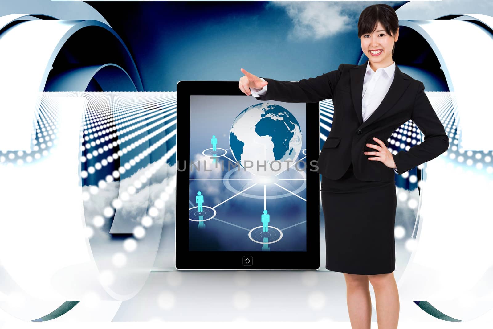 Smiling businesswoman pointing against abstract design in blue and white