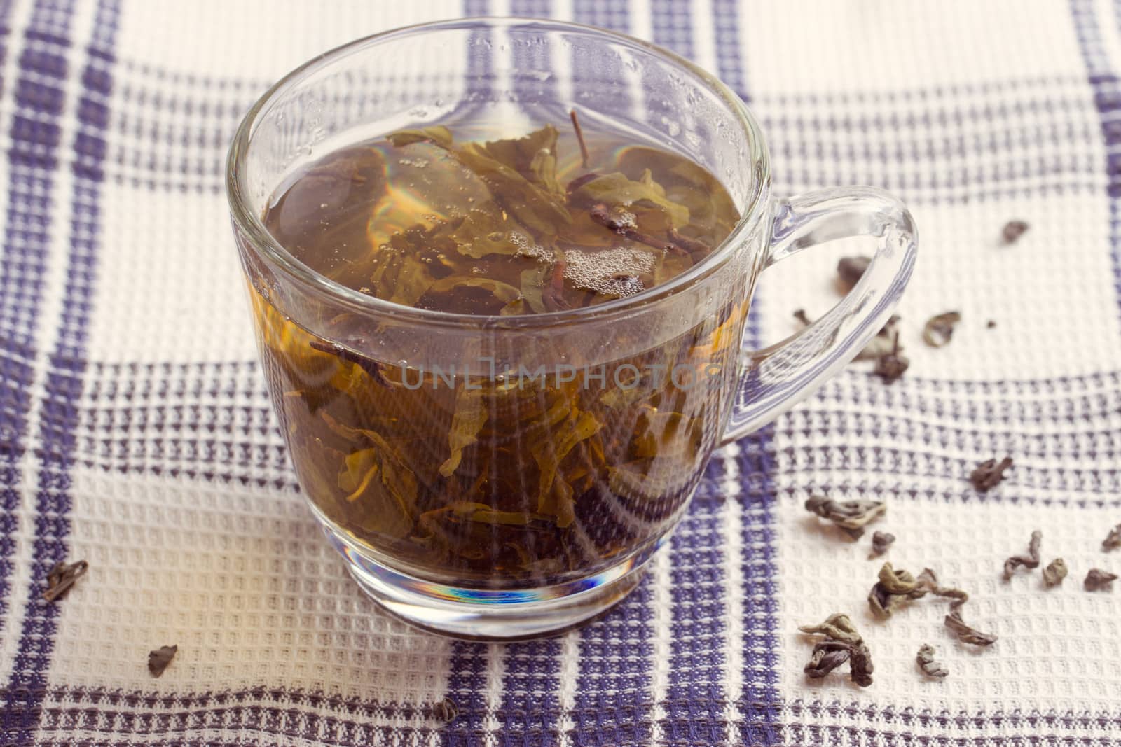 Green leaf tea in a transparent cup