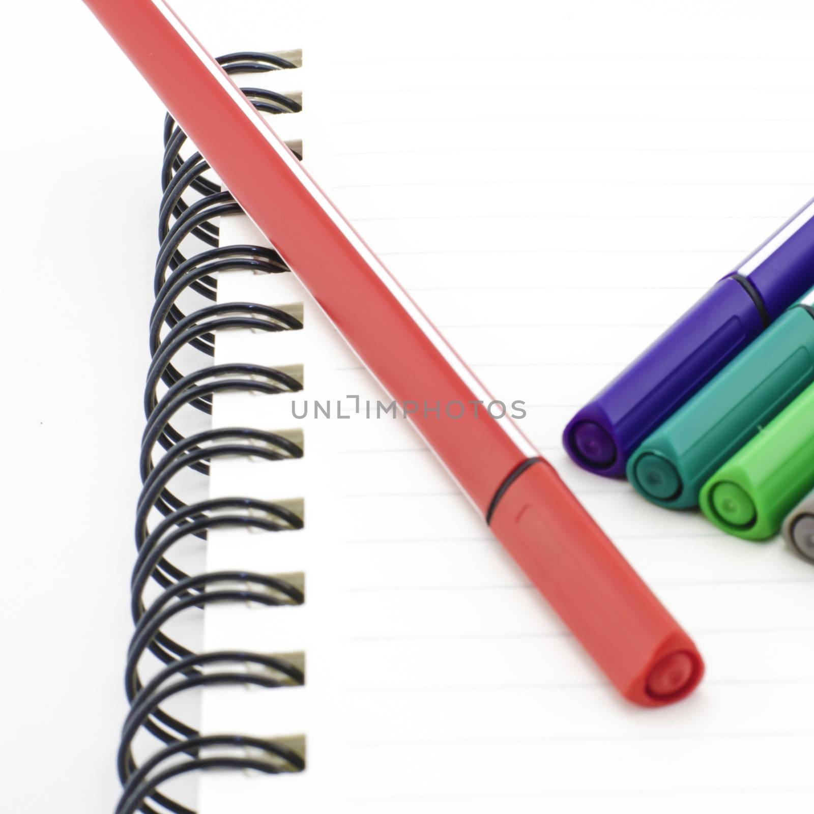 colorful pen with notebook isolated on white background