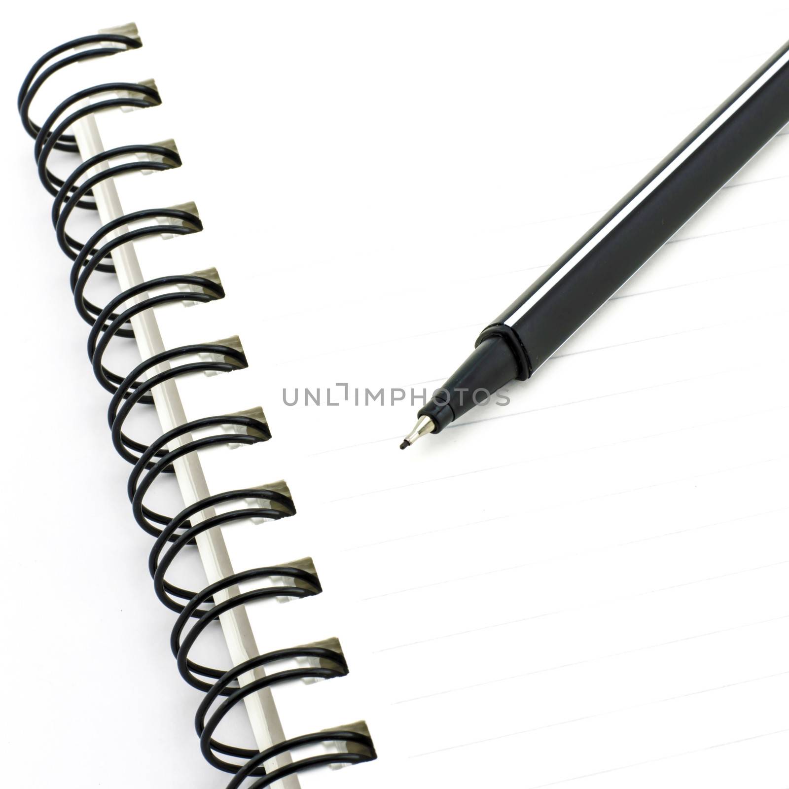 black pen with notebook isolated on white by ammza12
